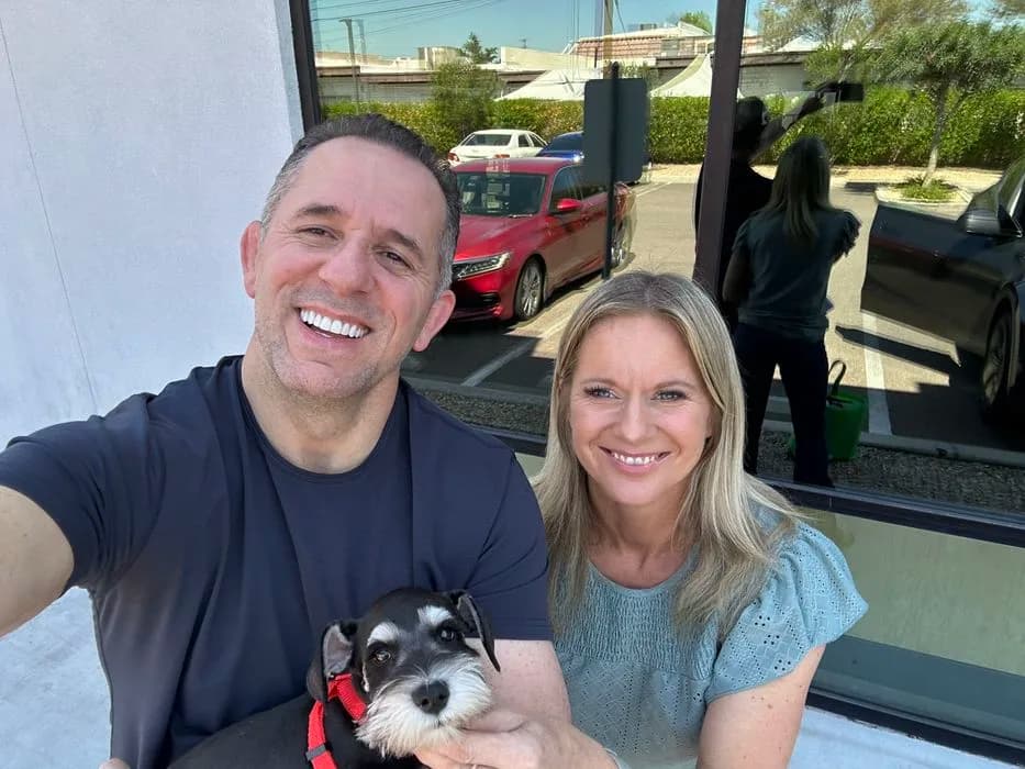A couple holding their miniature schnauzer puppy